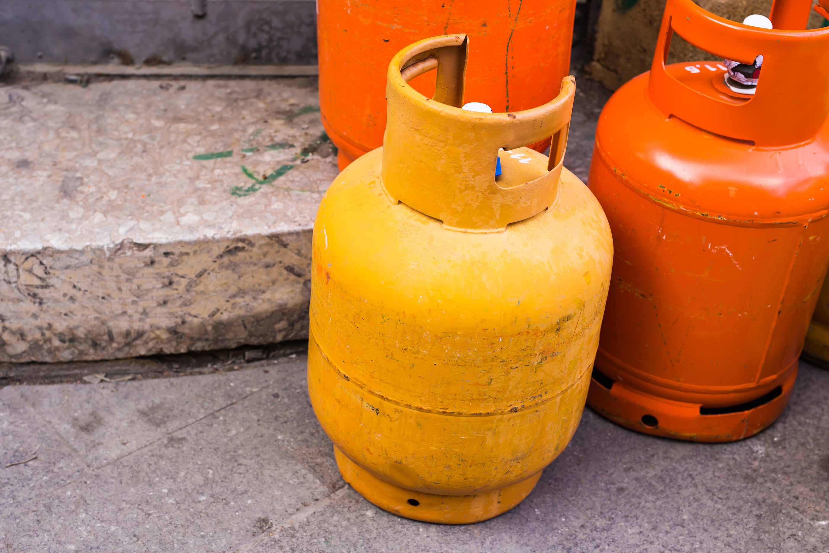 Rows of multiple red gas containers. Cooking gas cylinders. Rows of multiple red gas containers. Cooking gas cylinders.